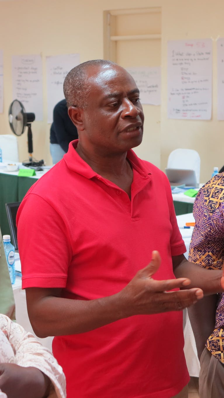 Entraîneur Koffi Aglébé en conversation avec des participants du programme
