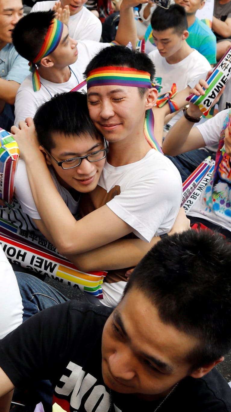 Demonstranten in Taiwan omhelzen elkaar nadat bekend werd gemaakt dat het constitutioneel hof besloot dat mensen van dezelfde sekse met elkaar mogen trouwen