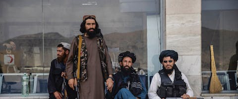 Taliban-strijders rusten uit bij het vliegveld van Kabul na het vertrek van de Amerikaanse troepen, 31 augustus 2021.