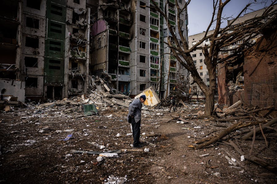 TOPSHOT - A man stands in front of a residential building damaged in yesterday's shelling in the city of Chernihiv on March 4, 2022. - Fourty-seven people died on March 3 when Russian forces hit residential areas, including schools and a high-rise apartment building, in the northern Ukrainian city of Chernihiv, officials said. (Photo by Dimitar DILKOFF / AFP) (Photo by DIMITAR DILKOFF/AFP via Getty Images)