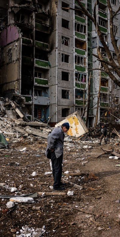 TOPSHOT - A man stands in front of a residential building damaged in yesterday's shelling in the city of Chernihiv on March 4, 2022. - Fourty-seven people died on March 3 when Russian forces hit residential areas, including schools and a high-rise apartment building, in the northern Ukrainian city of Chernihiv, officials said. (Photo by Dimitar DILKOFF / AFP) (Photo by DIMITAR DILKOFF/AFP via Getty Images)