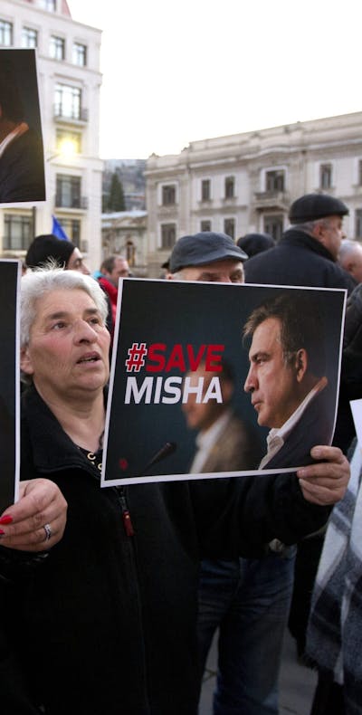 Meerdere aanhangers van de voormalige Georgische president Mikheil Saakashvili hebben zich verzameld voor het regeringsgebouw in Tbilisi, Georgië, op woensdag 4 januari 2023. Ze houden posters vast waarin ze oproepen voor de vrijlating van Saakashvili.