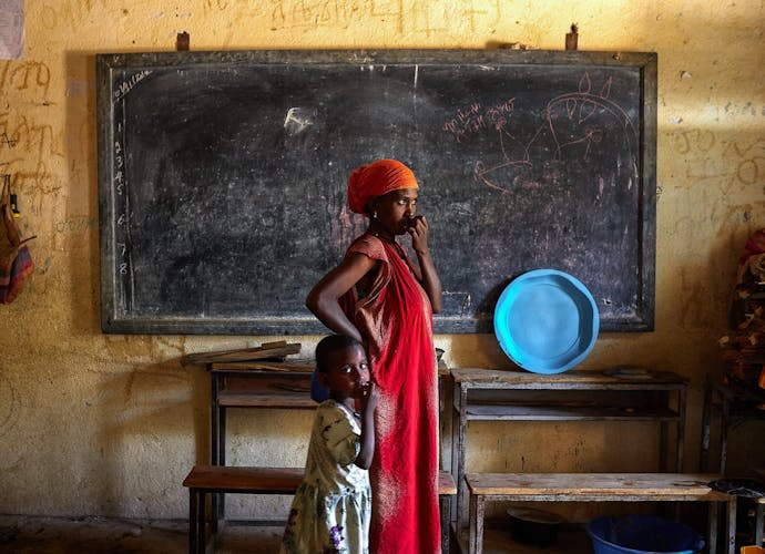 A woman looks out onto the street with her daughter inside an IDP Center. Northern Ethiopia is still suffering from the effects of the 2020 war, now on pause. More than 800,000 women and children need help, but major humanitarian organisations have stopped food shipments because of suspicions of theft. (Photo by Edgar GutiÈrrez / SOPA Images/Sipa USA)