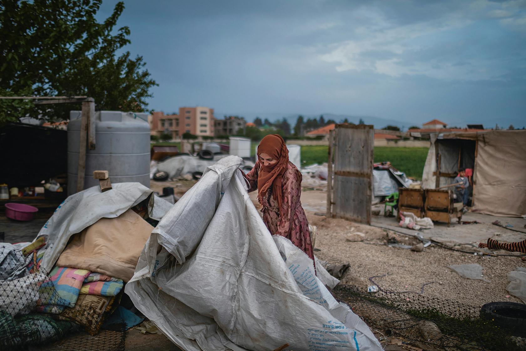 On May 5th, 2023, Yazi, 45, a Syrian refugee from Raqqa tries to rebuild her tent near Marj, Beqaa Valley, Lebanon. She is afraid after the Army intelligence destroyed her tent on May 2nd. Diego Ibarra Sánchez