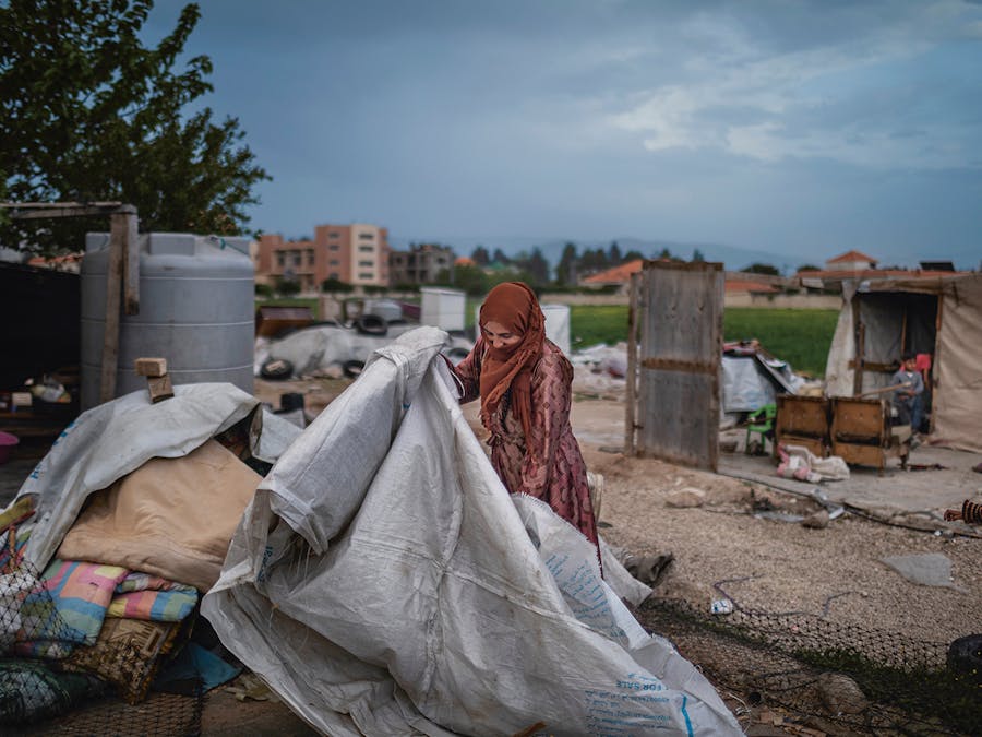 On May 5th, 2023, Yazi, 45, a Syrian refugee from Raqqa tries to rebuild her tent near Marj, Beqaa Valley, Lebanon. She is afraid after the Army intelligence destroyed her tent on May 2nd. Diego Ibarra Sánchez
