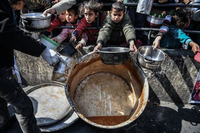 Palestijnen wachten op voedselhulp in Rafah.