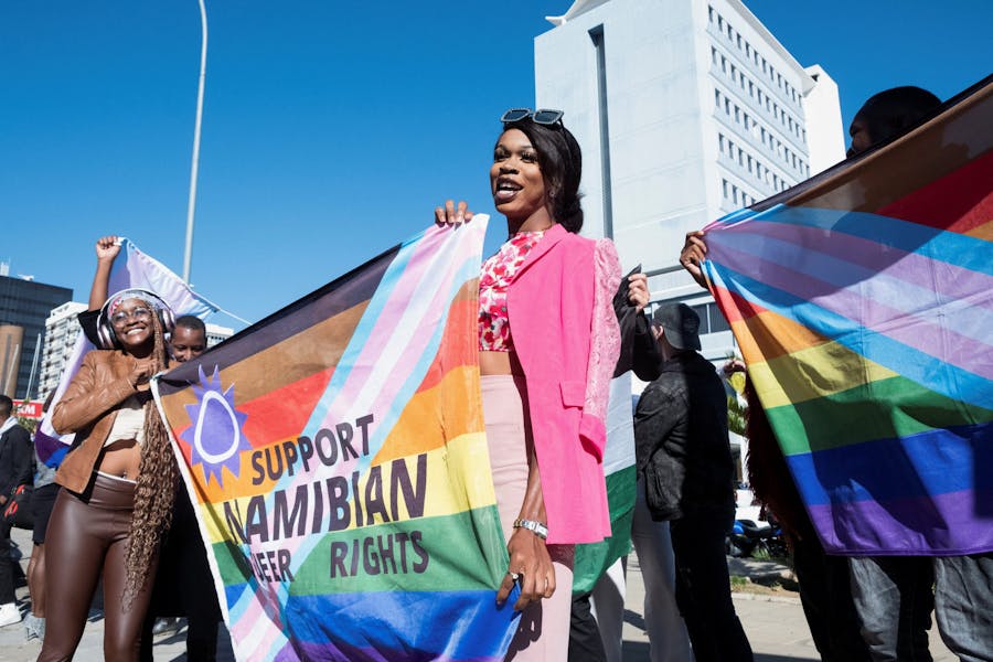 Mensen houden spandoeken vast ter ondersteuning van LGBTQIA-rechten buiten het hooggerechtshof dat een baanbrekende uitspraak deed ten gunste van LGBTQIA-gemeenschappen in Windhoek, Namibië, juni.